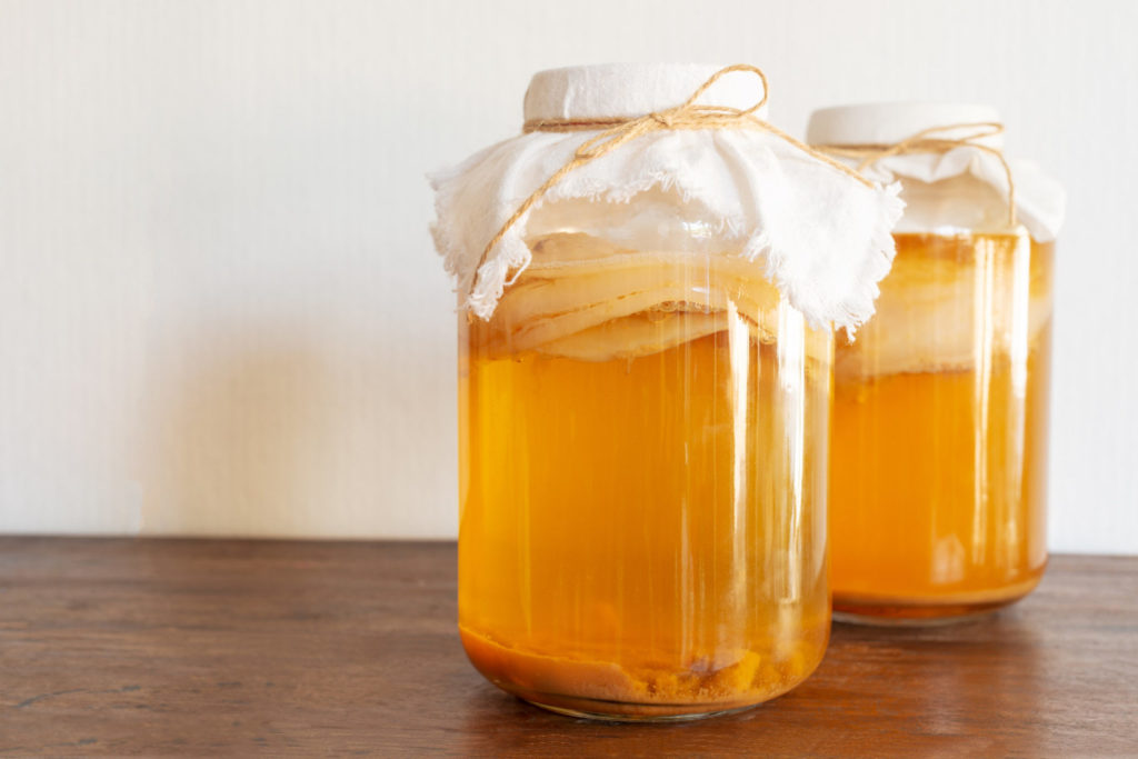 jar of fermenting organic kombucha on table